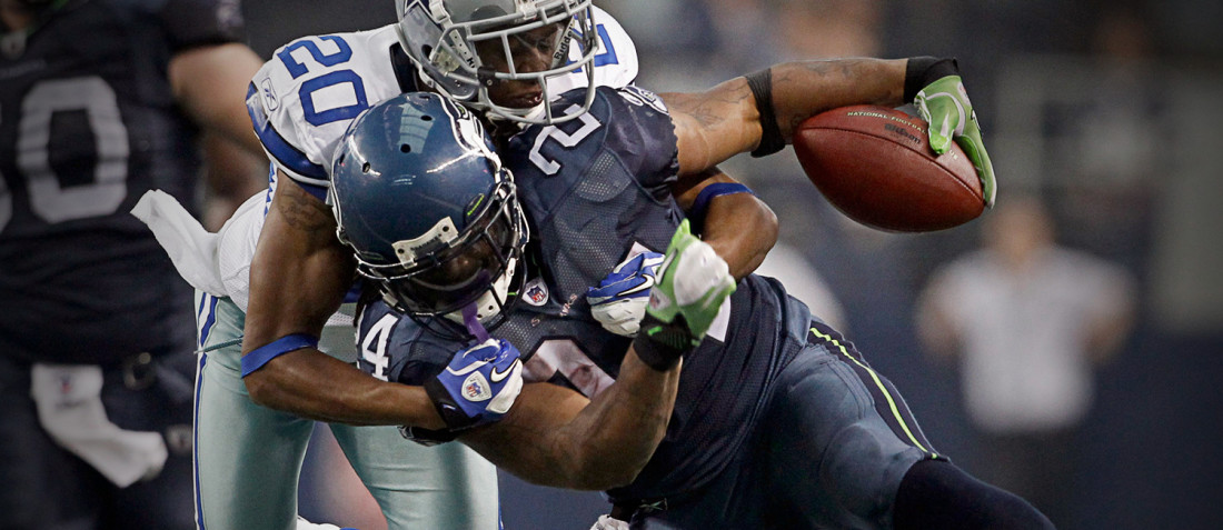 Marshawn Lynch carries the football versus the Dallas Cowboys