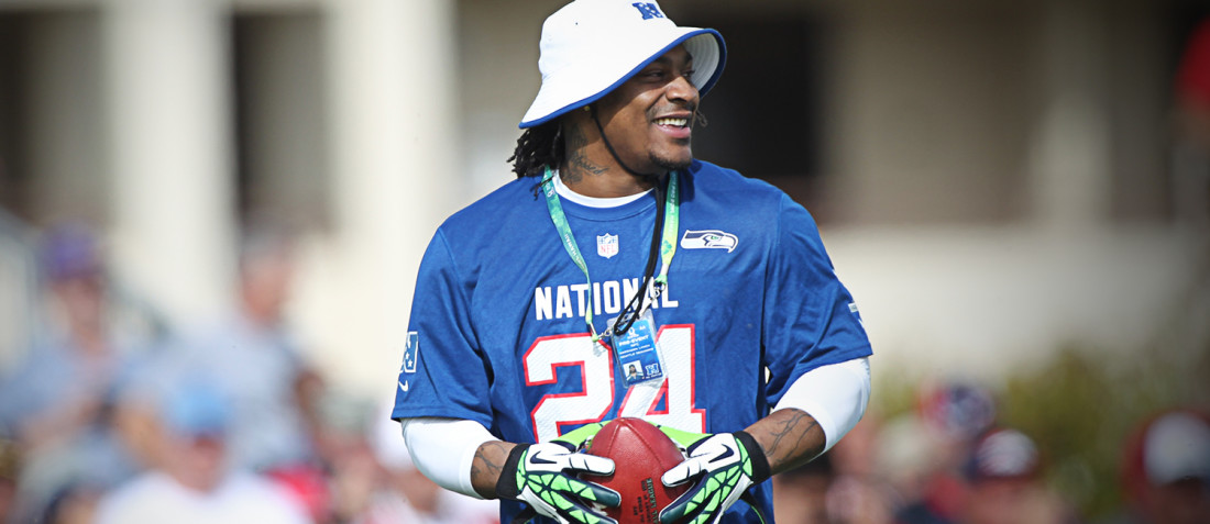 Marshawn Lynch holds onto a football at the 2011 Pro Bowl